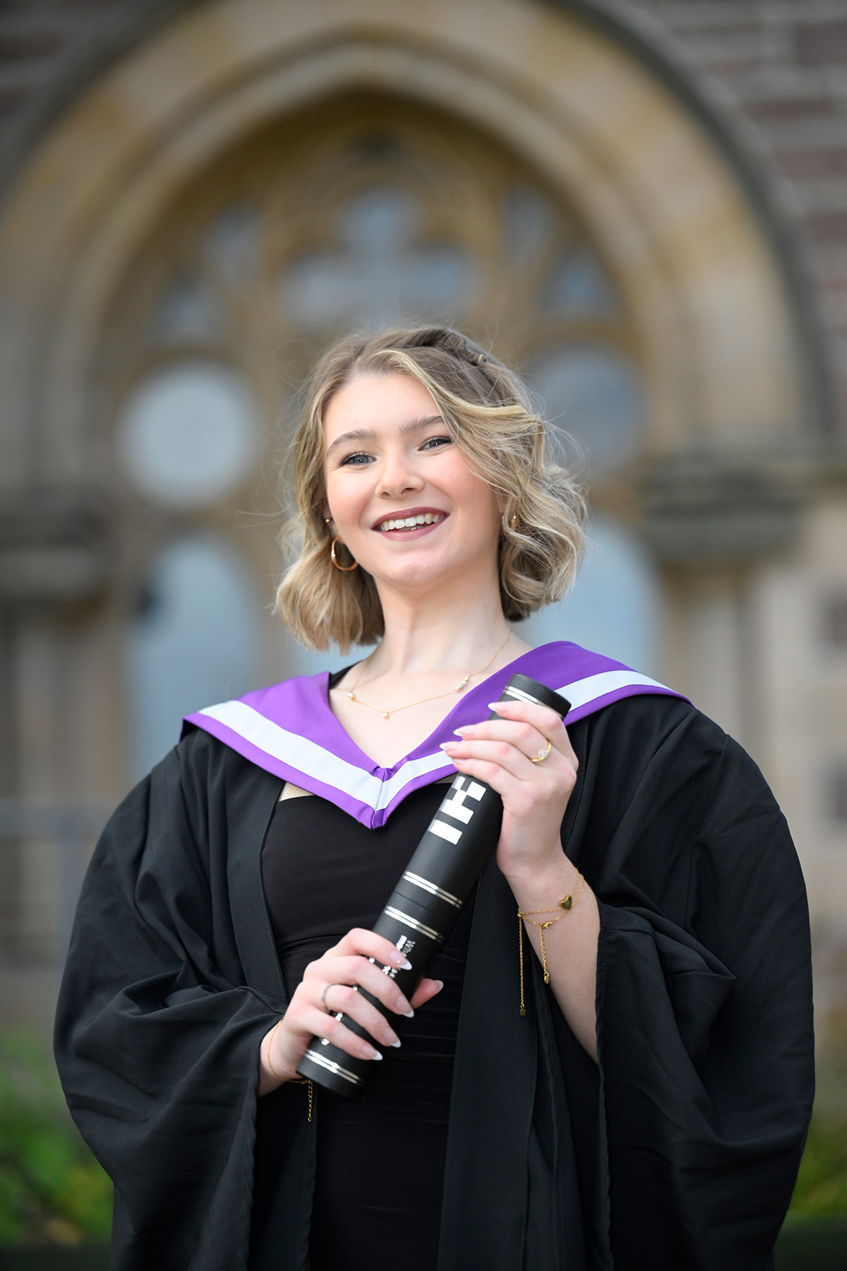 Graduate Megan Short holding a scroll Graduate Megan Short holding a scroll