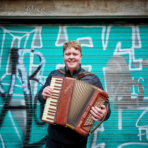 Person playing an accordion Person playing an accordion