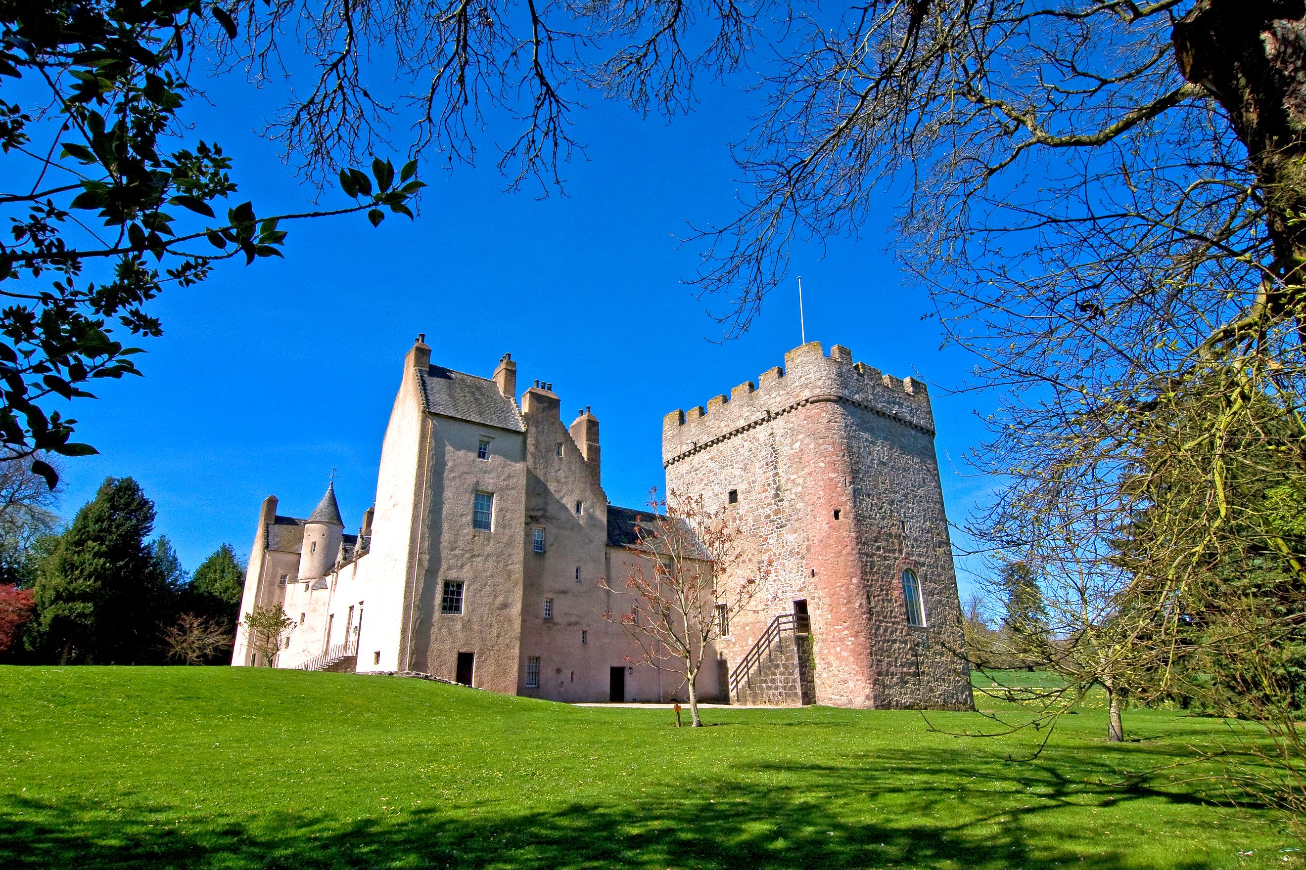 A castle with a grassy slope leading to it A castle with a grassy slope leading to it