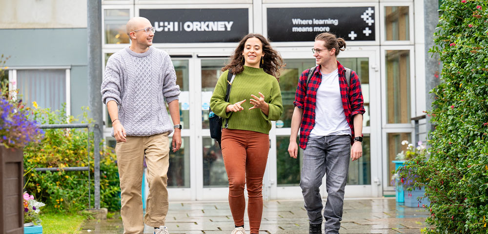 Three students walking outside UHI Orkney
